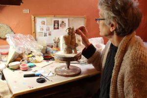 Ruth sculpting a figure in clay
